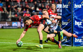 David Havili of the Crusaders scores a try in the tackle of  Dane Haylett-Petty of the Rebels during the Super Rugby match
