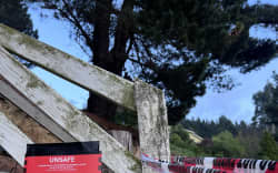 A red sticker at the boundary of a Dunedin property on 7 October after massive downpours caused floods, landslides and road closures.