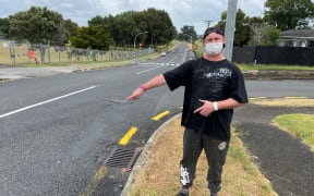 Jared Ifwersen points to where he was hit by a speeding car in 1985.