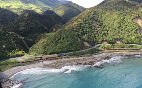 A train is trapped between slips on SH1 after Monday's earthquake.