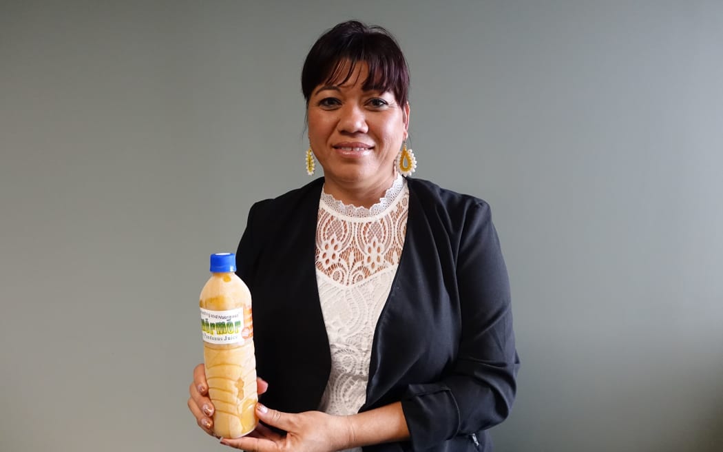 Iva Reimers-Roberto, from Robert Reimers Enterprises, holding a bottle of Pandanus juice.