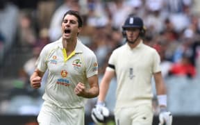 Pat Cummins of Australia celebrates taking the wicket of Haseeb Hameed of England during day 1 of the third Ashes Test between Australia and England at the MCG in Melbourne, 2021.