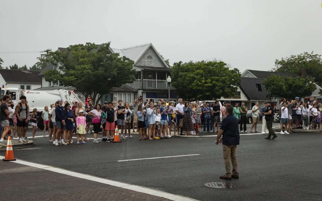 People line the street across from the Rehoboth Beach Police Department in Delaware, as US President Joe Biden makes a statement after his Republican opponent Donald Trump was injured in a shooting at an election rally, on 13 July, 2024.