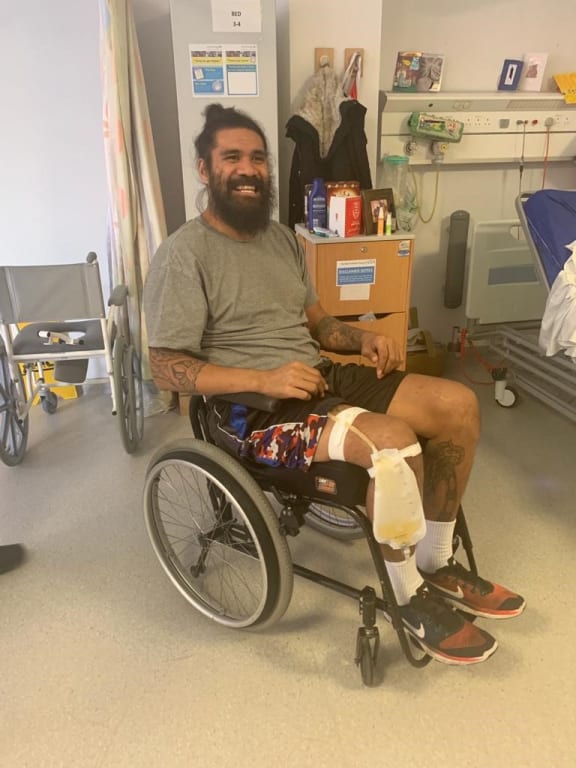 Mose Masoe sitting up for the first time after seven weeks of lying flat in a hospital bed.