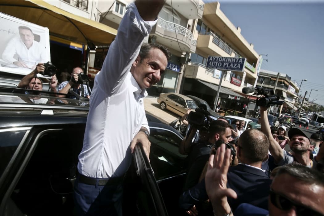 New Democracy leader Kyriakos Mitsotakis sallutes supporters.