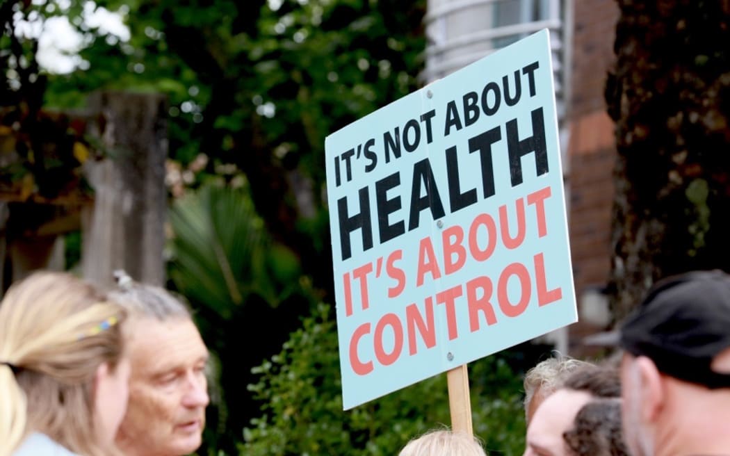 Supporters outside the High Court in Auckland hearing a case taken by Te Whatu Ora over parents of a baby needing urgent heart heart surgery refusing to allow blood from vaccinated people to be used during the operation.