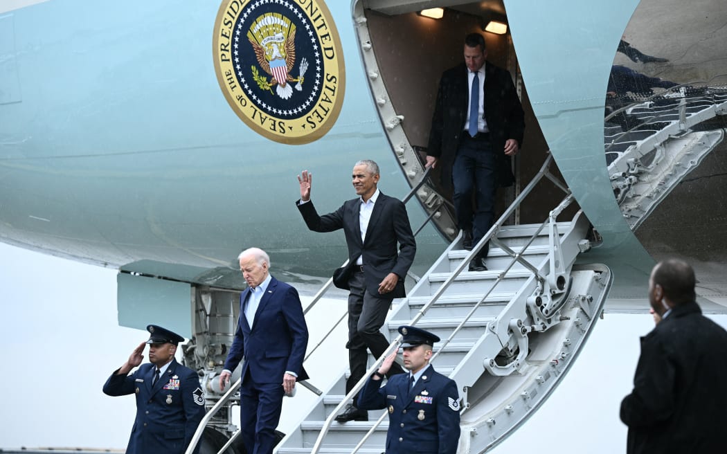 US President Joe Biden and former president Barack Obama step off Air Force One upon arrival at John F. Kennedy International Airport in the Queens borough of New York City on 28 March, 2024. Biden travels to New York to hold a fundraiser event with former US Presidents Barack Obama and Bill Clinton.