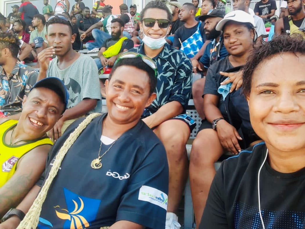 Elsie enjoys watching some local footy in PNG with friends and family.