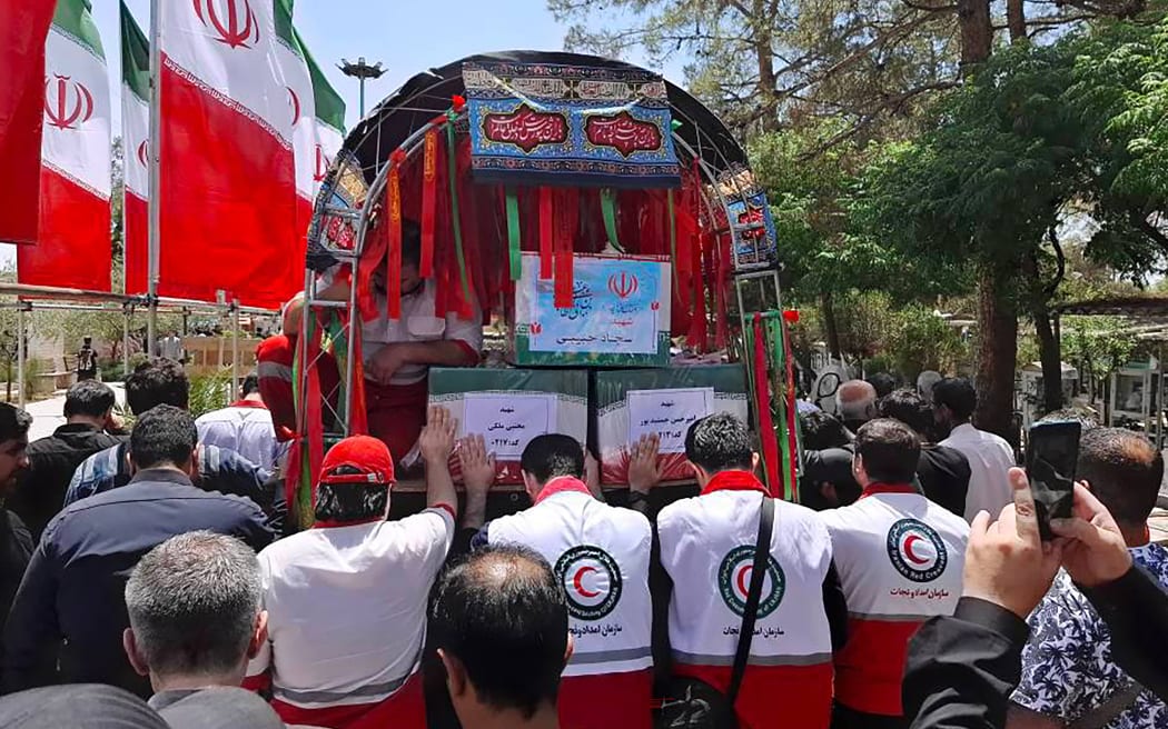 A photo provided by the Iranian Red Crescent on 19 June, 2025 shows the funeral procession of two Iranian Red Crescent members who were killed during an Israeli strike in Tehran.