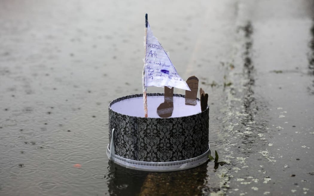 Scenes on Surrey Street, South Dunedin, Friday evening, a homemade raft.