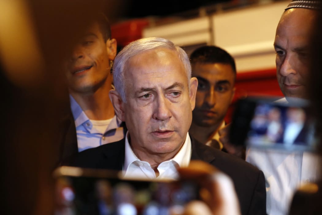 Israeli Prime Minister Benjamin Netanyahu tours the city of Lod early on 12May.
