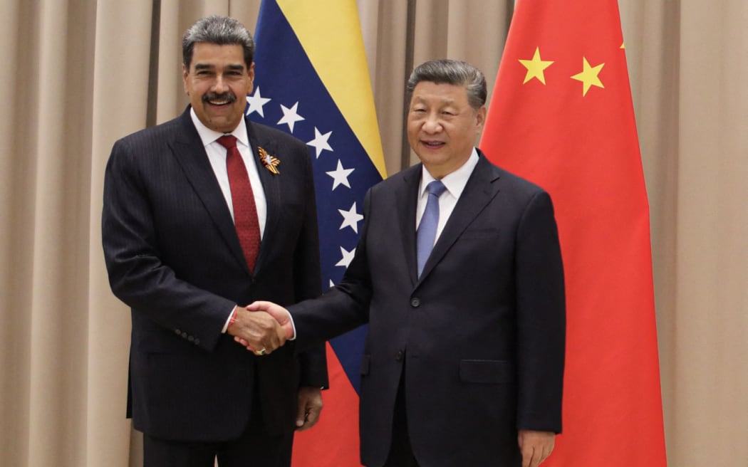 Handout picture released by Venezuelan Presidency showing Venezuelan president Nicolas Maduro shaking hands with Chinese President Xi Jinping during a meeting in Moscow on May 9, 2025.