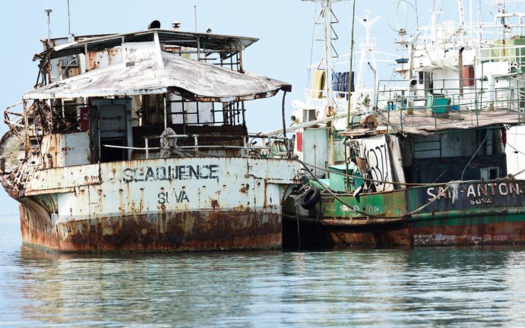 The 50-year-old fishing boat Sequence (left) alongside another abandoned vessel in Suva Harbour. Pictured on Feb 14, 2025. (Harry Pearl/Benar News)
