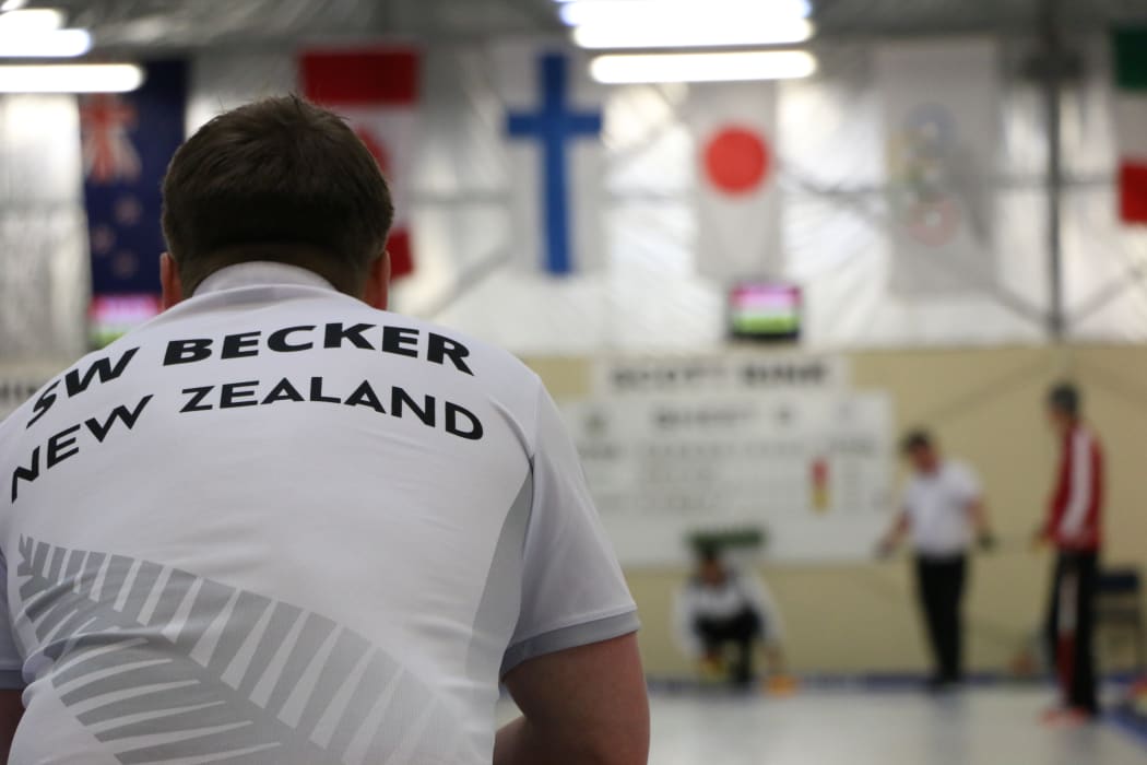 New Zealand men’s skip Scott Becker watches as his teammate prepares to release a stone