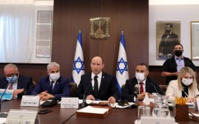 Israeli Prime Minister Naftali Bennett (C) attends a cabinet meeting at his office in Jerusalem, on October 24, 2021.