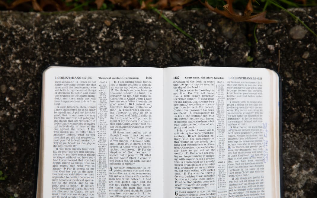 Cassie Dean leafs through the pages of her childihood bible, the New World Translation of the Holy Scriptures.