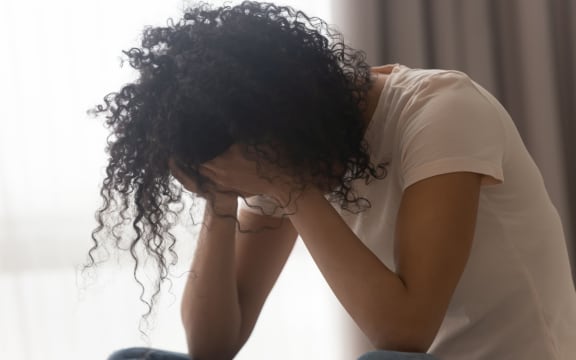 Depressed african American young woman sit at home feel desperate down suffering from relationships problems breakup, upset black girl crying having life troubles,