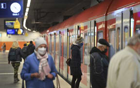 People wear masks on public transport in Munich, Germany.