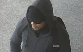 The man was spotted on CCTV walking by the store about 30 minutes prior to the robbery.