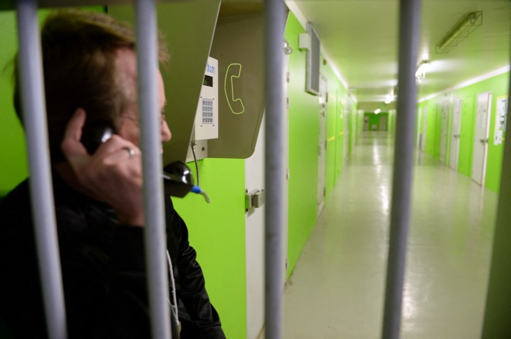 An inmate using a telephone in Prison