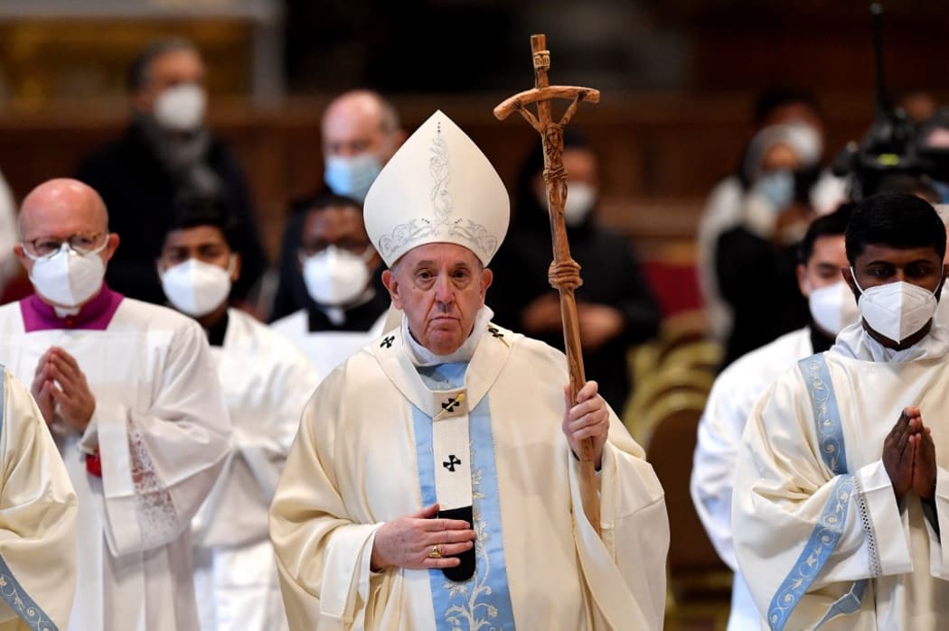 Pope Francis leaves at the end of the New Year's day mass in St. Peter's Basilica at the Vatican on January 1, 2022. (Photo by Tiziana FABI / AFP)