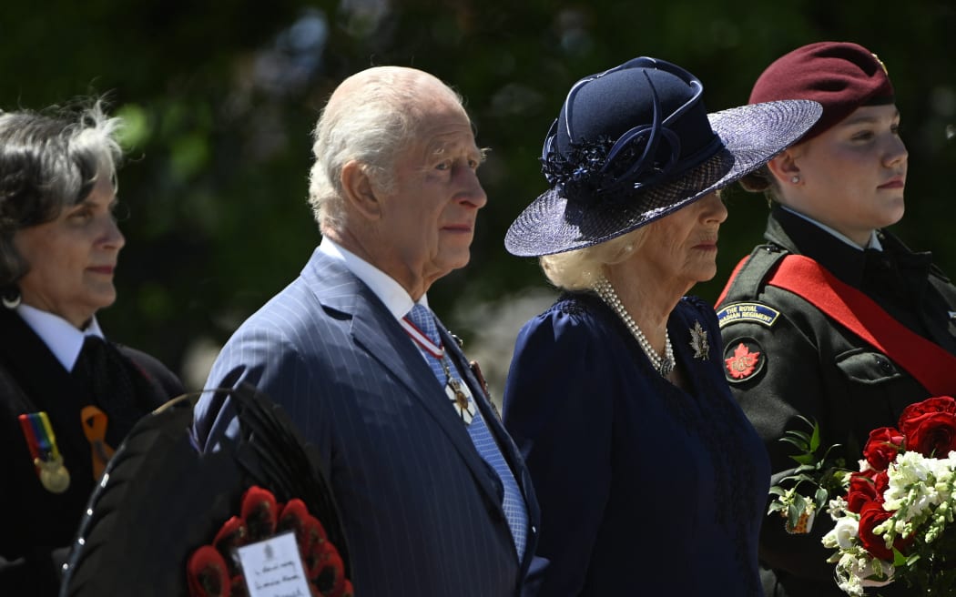 Britain's King Charles III and Queen Camilla arrive to lay a wreath at The Tomb of the Unknown Soldier at the National War Memorial in Ottawa, Canada on May 27, 2025. King Charles III was given an enthusiastic welcome on May 26 by Canadians who turned out in droves to see their monarch on his historic visit to open parliament, as part of the pushback against US President Donald Trump's annexation threats. The 76-year-old king, who is Canada's head of state as part of the Commonwealth, was greeted at the airport by Prime Minister Mark Carney, who has invited him to give an address opening Canada's new legislature on May 27. (Photo by ANDREJ IVANOV / AFP)