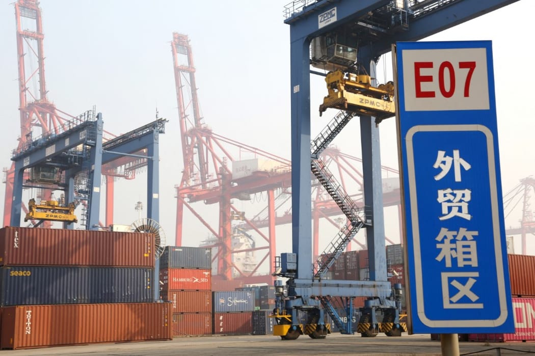 Cranes lift  containers at the Lianyungang Port, which is among the 10 largest ports in China  Lianyungang city, east Chinas Jiangsu province, 7 November 2020.