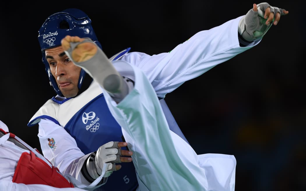 Tonga's Pita Taufatofua takes on Iran's Sajjad Mardani during their men's in his +80kg taekwondo qualifying bout in Rio.