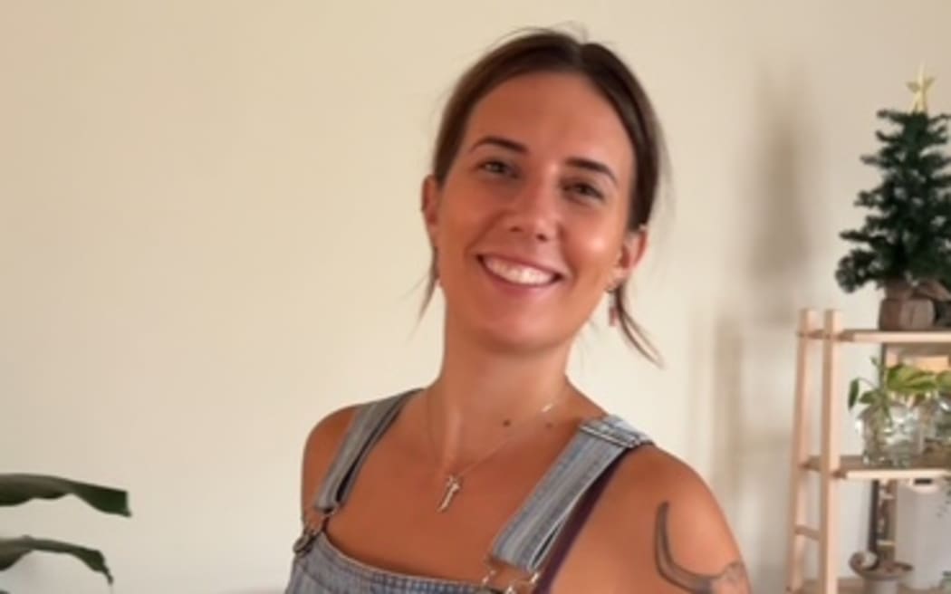 Missing tourist named as Katherine has brown hair, tattoos and in this photo is wearing blue overalls and a purple singlet underneath.