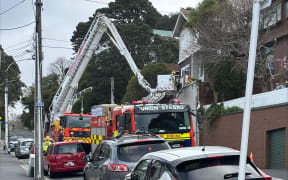 The Fire Service looking at a property on The Terrace in Wellington damaged by high winds.