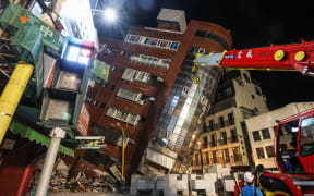 This photo taken by Taiwan's Central News Agency (CNA) on April 3, 2024 shows the damaged Uranus Building in Hualien, after a major earthquake hit Taiwan's east. A major 7.4-magnitude earthquake hit Taiwan's east on the morning of April 3, prompting tsunami warnings for the self-ruled island as well as parts of southern Japan and the Philippines. (Photo by CNA / AFP) / Taiwan OUT - China OUT - Macau OUT / Hong Kong OUT RESTRICTED TO EDITORIAL USE