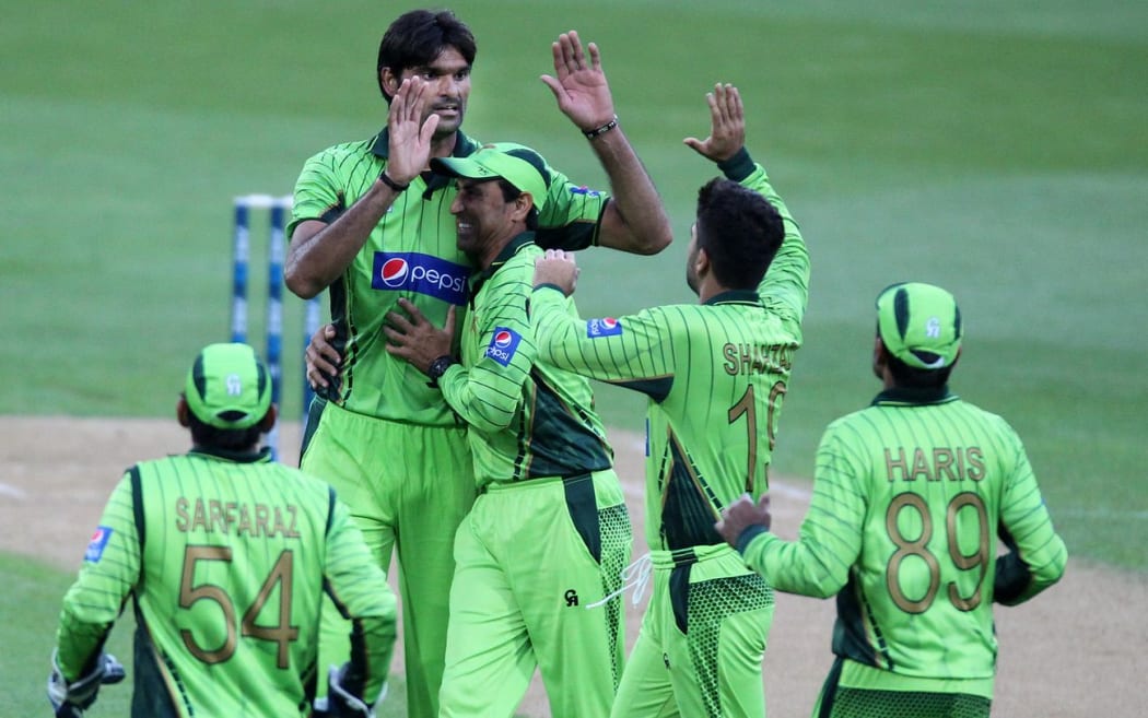 Mohammad Irfan celebrates taking the wicket of Martin Guptill.
