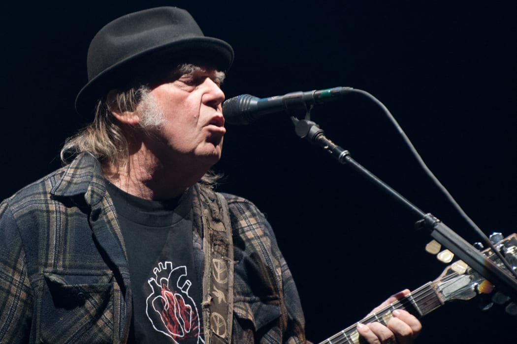 In this file photo taken on 7 July 2018 Neil Young performs on stage for his first time in Quebec City during 2018 Festival d'Ete.