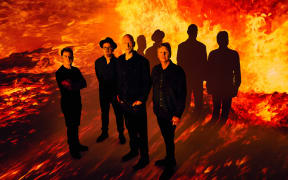 Midnight Oil the band standing in front of flames