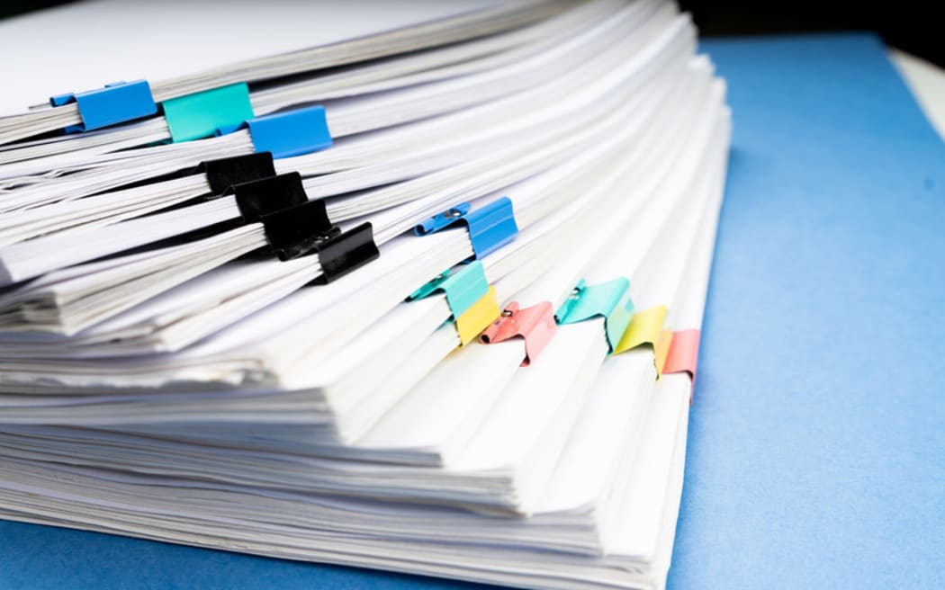 Mock up, stack of papers documents in archives files with paper clips on desk at offices, business concept.