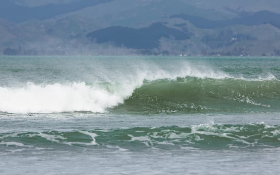 A wave breaks at the beach.