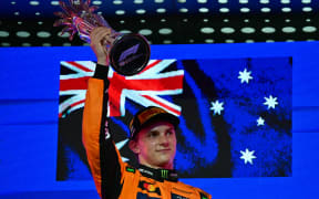 McLaren's Australian driver Oscar Piastri celebrates on the podium after winning the 2025 Saudi Arabia Formula One Grand Prix.