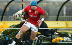 Jack Nowell (front) is tackled by the Hurricanes' Julian Savea.