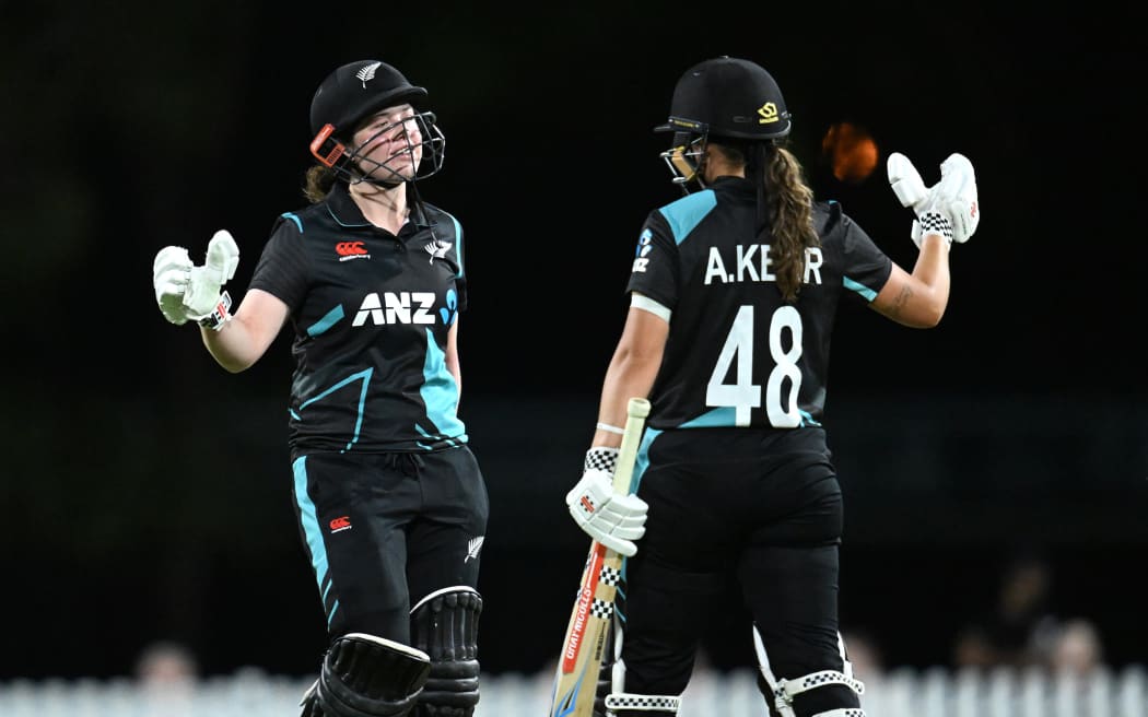 Georgia Plimmer (L) celebrates a half-century for the White Ferns against Australia.