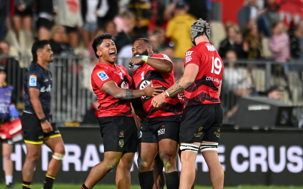Manumaua Letiu, George Bower and Tahlor Cahill of the Crusaders celebrate.
