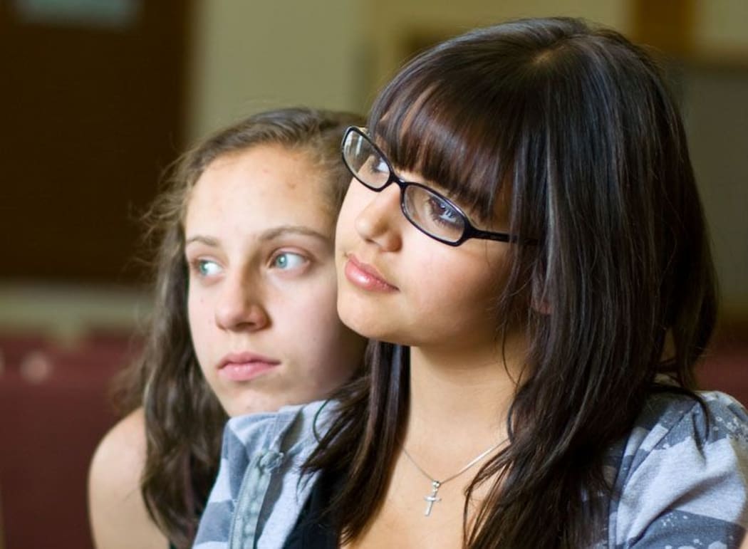 Two girls listening