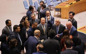NEW YORK, NEW YORK - DECEMBER 19: Palestinian Ambassador to the United Nations Riyad Mansour (3rd R) looks on as he speaks with members of the UN Security Council as they break during a meeting on the Israel-Hamas war at the United Nations headquarters on December 19, 2023 in New York City. The Security Council is meeting to hold a vote on a resolution proposed by the United Arab Emirates on behalf of Arab and Muslim states calling for limiting the fighting and dramatically increasing humanitarian aid for the people in Gaza. The vote was originally scheduled for Monday but was postponed to meet the US objections to the wording of the draft resolution. The US previously used its veto power on the council and vetoed a resolution calling for a Gaza cease-fire on December 8 and voted "No" on a cease-fire on December 12 in a vote in the General Assembly.   Michael M. Santiago/Getty Images/AFP (Photo by Michael M. Santiago / GETTY IMAGES NORTH AMERICA / Getty Images via AFP)