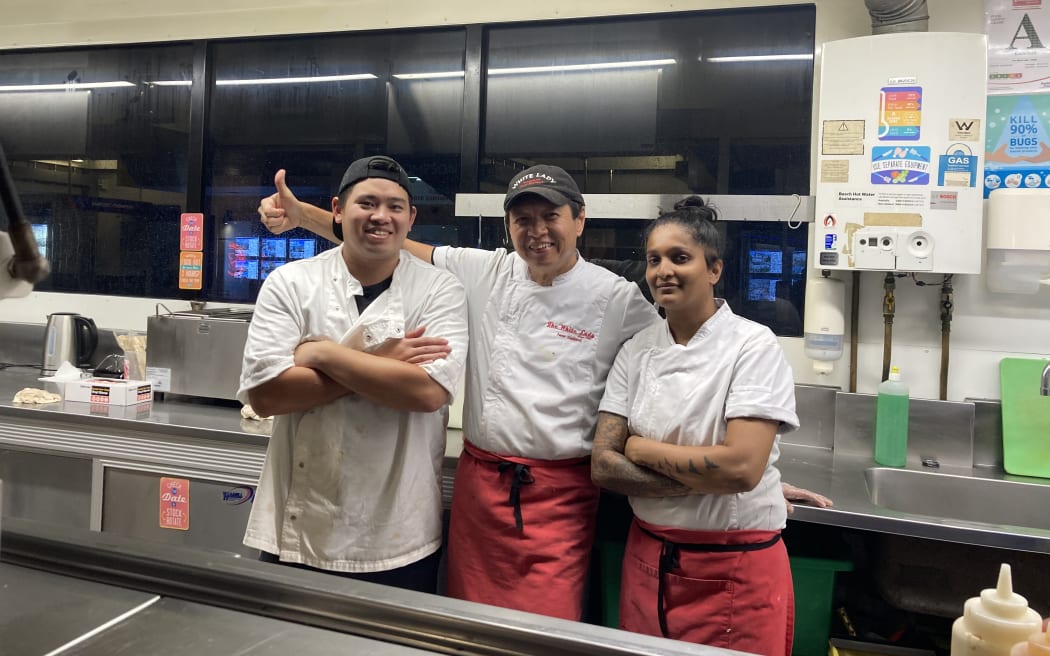 Chefs Nick, Eddie and Yasmeen take time out of making burgers at the White Lady.