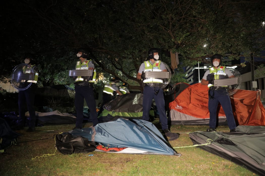 Police ripped down tents at the protest site in Wellington during an early morning operation.