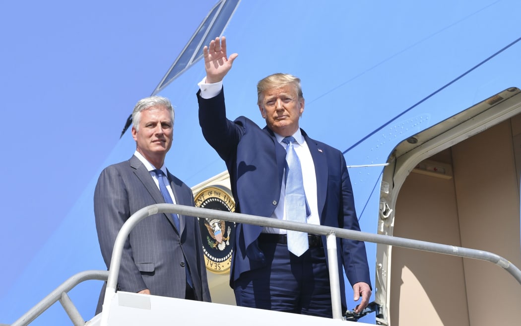 US President Donald Trump(R)waves next to new national security advisor Robert O'Brien on September 18, 2019 at Los Angeles International Airport in Los Angeles, California.