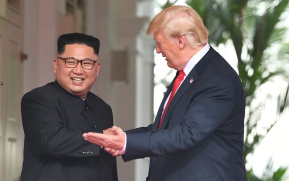 US President Donald Trump (R) gestures as he meets with North Korea's leader Kim Jong Un (L) at the start of their historic US-North Korea summit, at the Capella Hotel on Sentosa island in Singapore on June 12, 2018.