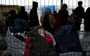 Child migrant queuing to be registered