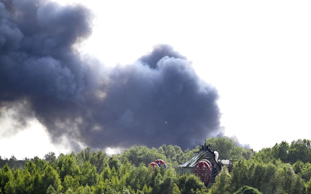 Smoke caused by a fire pictured at the festival site of the Tomorrowland electronic music festival, Wednesday 16 July 2025, in Boom. The first weekend of the festival takes place at the 'De Schorre' terrain in Boom, from 18 to 20 July. BELGA PHOTO TOM GOYVAERTS (Photo by Tom Goyvaerts / BELGA MAG / Belga via AFP)