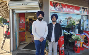 Rajbir Singh and his father, Sukhdeep, in front of the dairy that they run on Marua Road in Ellerslie.