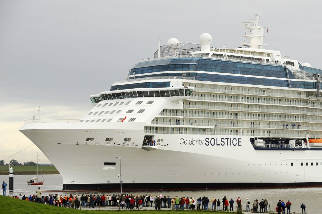 Onlookers watch luxury cruise liner "Celebrity Solstice" being towed past a lock on the Ems river in Gandersum, northern Germany, on September 29, 2008. The ship, Germany's biggest of its kind, built at the Meyer Werft shipyards in Papenburg, is due to reach the North Sea over the Ems river.